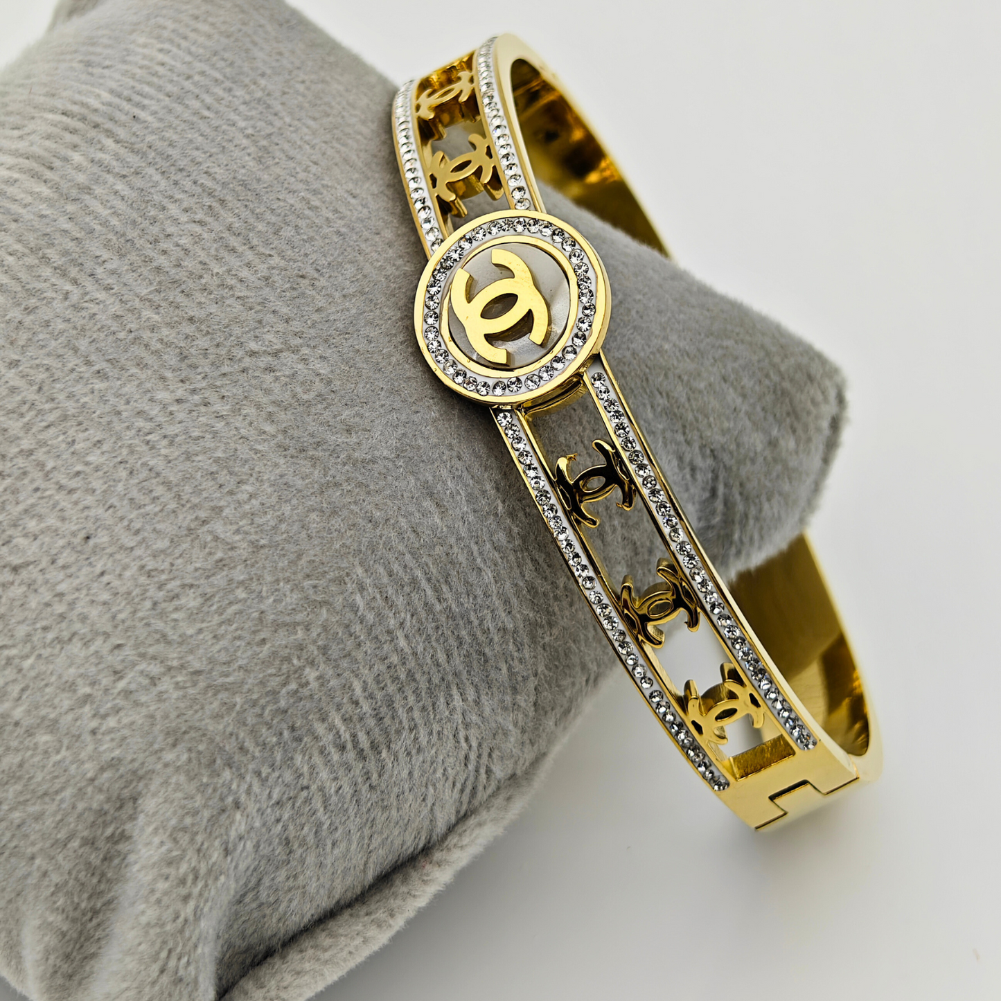 Regal Emblem: 18K Gold Plated Bangle with Iconic Logo and Crystal Pave  RGB221