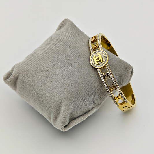 Regal Emblem: 18K Gold Plated Bangle with Iconic Logo and Crystal Pave  RGB221