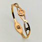 Elegant Harmony: 18K Gold Plated Bangle with Interlocking Charms and CZ Details RGB207