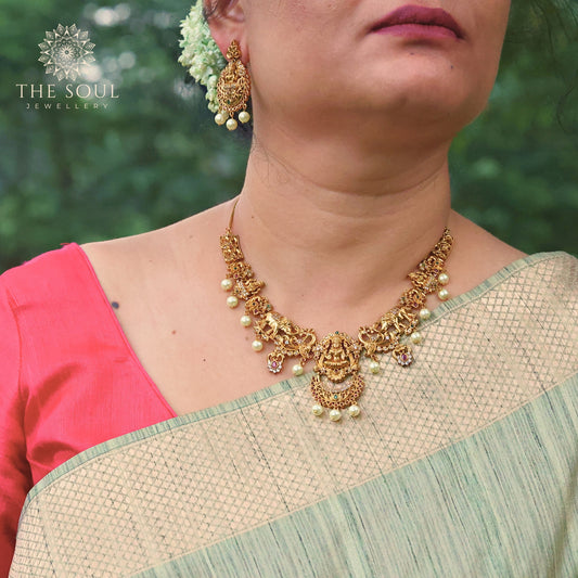 Mavisha Antique Matte Gold Plated Short Necklace Set with Lakshmi Idol, Elephant & Peacock Design