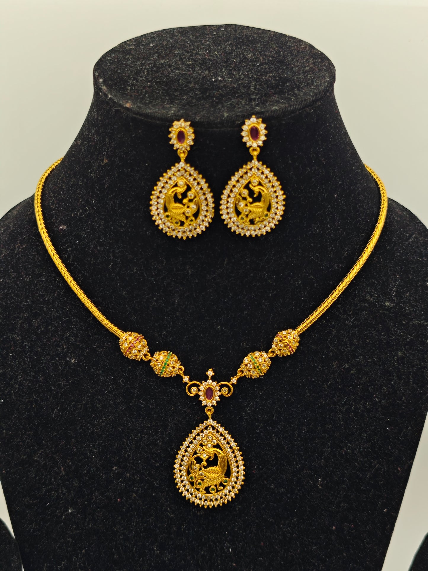 Aloka Antique Gold Plated Temple Necklace Set with Intricate Peacock Pendant and Ruby Accents – Traditional Ethnic Jewelry MGNS310