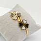 Elegant 18K Gold Plated Clover Bangle with Black and White Enamel Accents RGB255