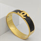 Luxury 18K Gold Plated Channel Logo Engraved Bangle with Black Leather Inlay – Anti-TarnishBracelet for Elegant Style RGB263