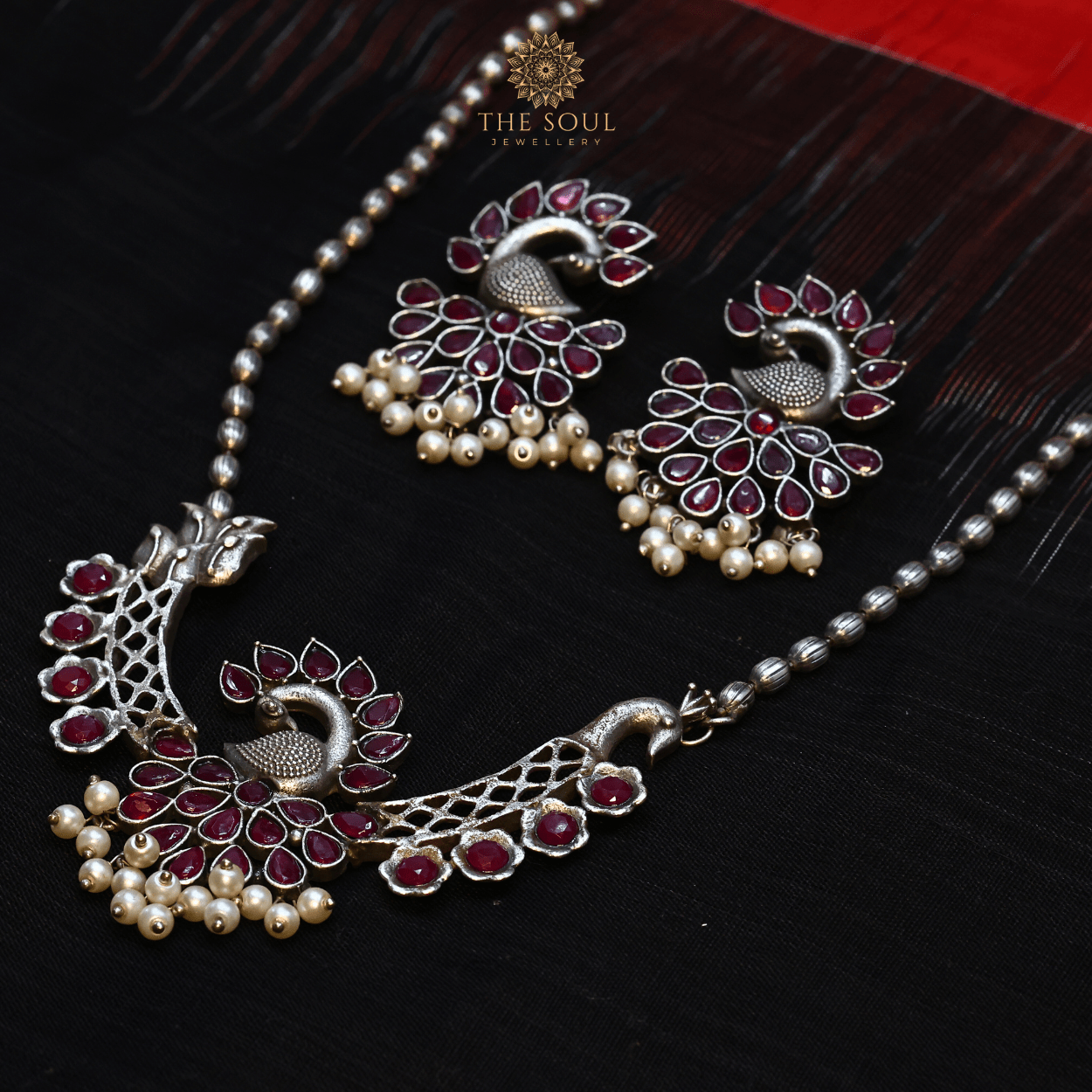 German Silver - Plated Peacock Necklace set with Red Gemstones and Gleaming Pearl Drops - The Soul Jewellery