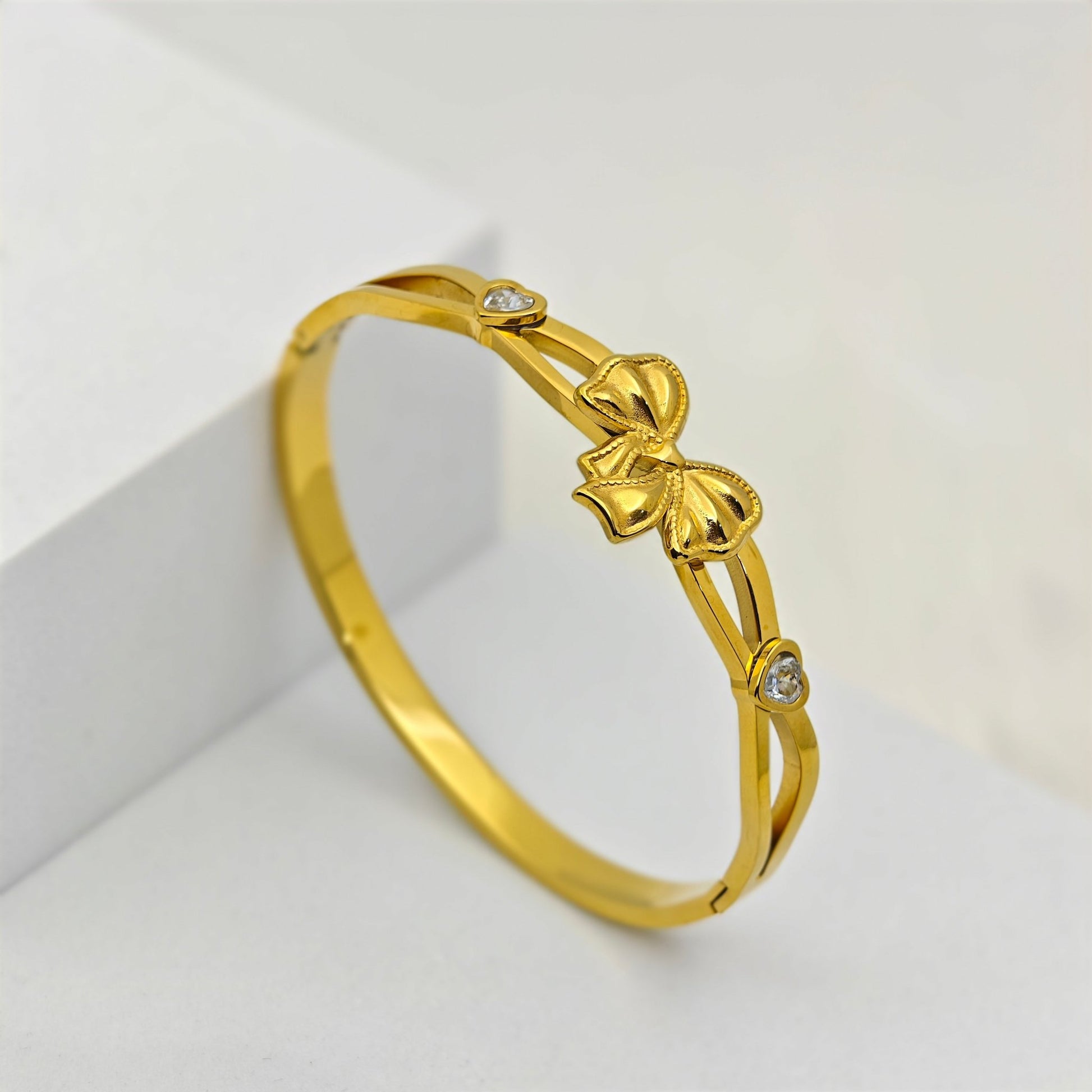 Elegant 18K Gold - Plated Bow Charm Bracelet – Anti - Tarnish Stainless Steel Bangle with Heart - Shaped Crystal Accents RGB425 - The Soul Jewellery