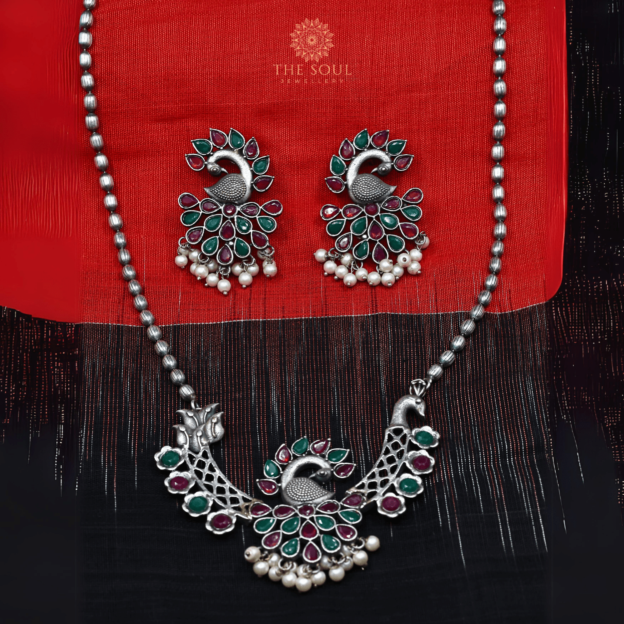 German Silver - Plated Peacock Necklace set with Red & Green Gemstones and Gleaming Pearl Drops - The Soul Jewellery