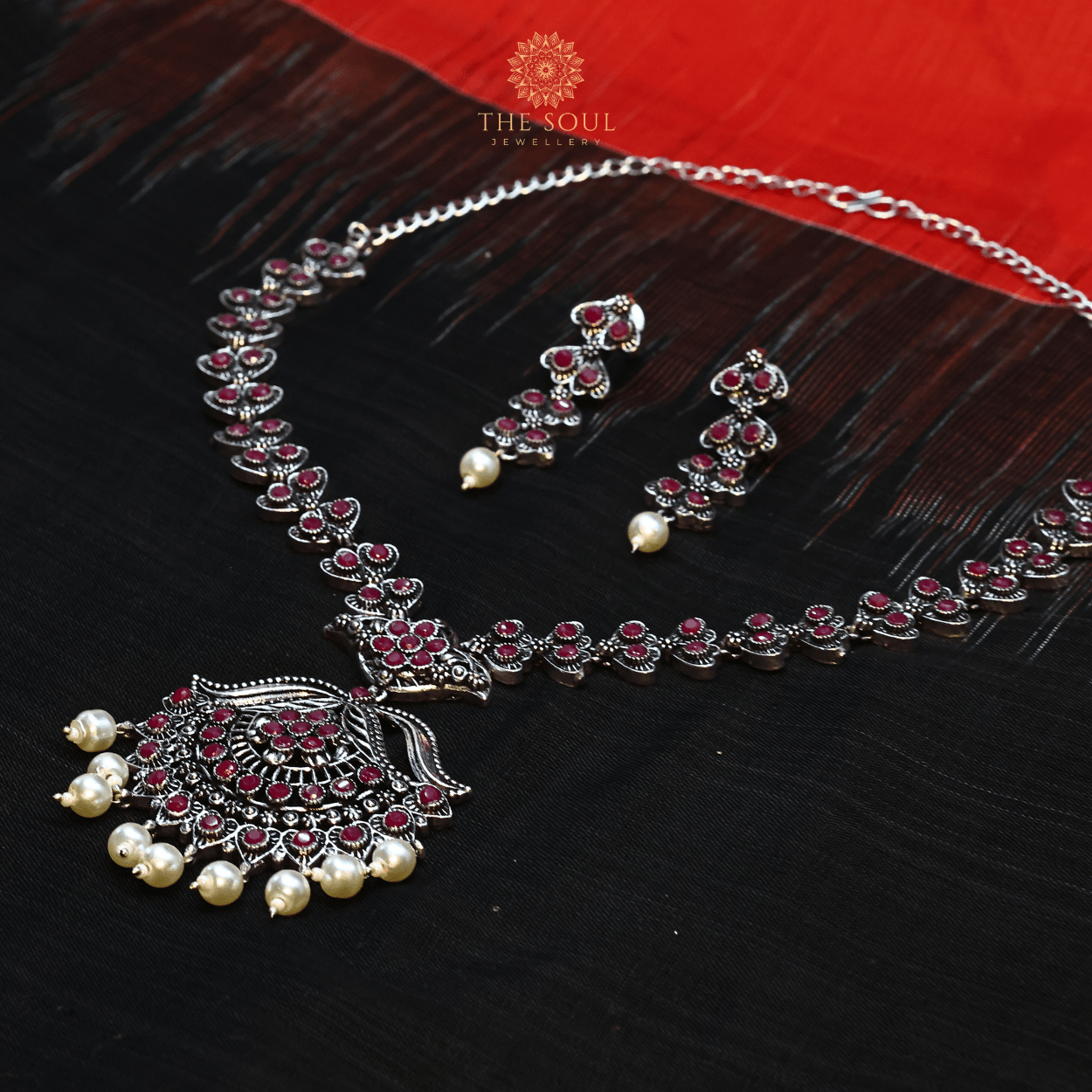 German Silver - Plated Necklace and Earrings Embellished with Red Gemstones and Pearl Drops - The Soul Jewellery