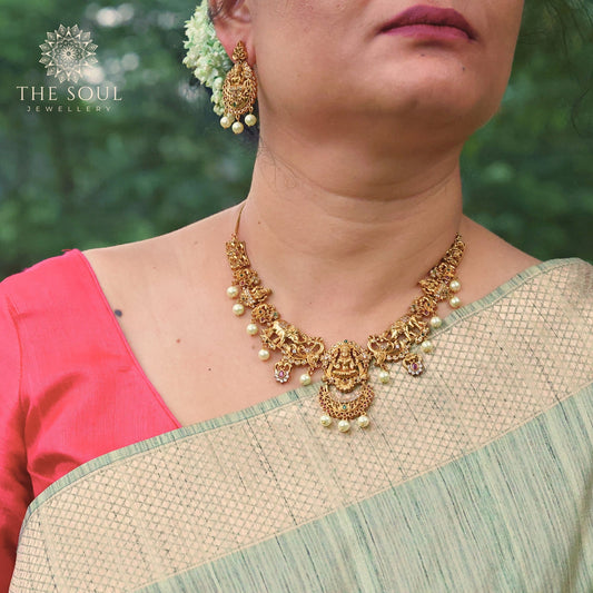 Mavisha Antique Matte Gold Plated Short Necklace Set with Lakshmi Idol, Elephant & Peacock Design - The Soul Jewellery