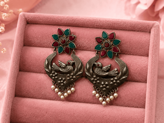 Bird Nest Motif Silver Lookalike Earring with Red and Green Stones and Pearl Drops for Women - The Soul Jewellery